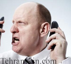 Portrait of businessman using two phones