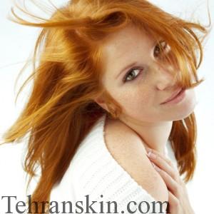 Sexy girl with red hair and freckles posing on white studio background